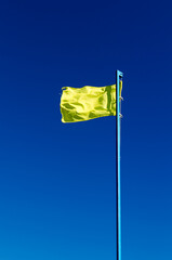 rescue yellow flag against the sky