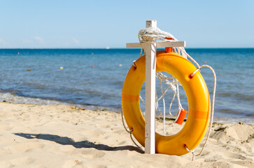 lifebuoy on the sand against the background of the sea