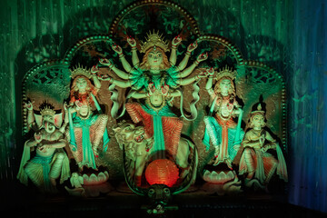 Obraz na płótnie Canvas Goddess Durga idol at decorated Durga Puja pandal, shot at colored light, at Kolkata, West Bengal, India. Durga Puja is biggest religious festival of Hinduism and is now celebrated worldwide.