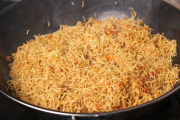 closeup, fried yellow noodles in a frying pan.