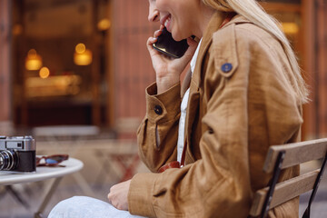 Close-up photo of lady photographer answering call