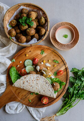 Home cooked Middle Eastern meal. Falafel Wrap with Tahini Sauce. Delicious and healthy food for light eater and weight watcher