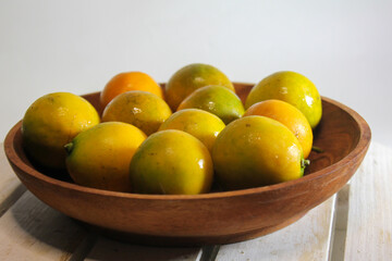 yellow fresh orange above wooden background