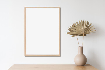 Blank picture frame mockup on white wall vertical template. Artwork in minimal interior design. View of modern style interior with canvas for painting or poster on wall. Minimalism concept