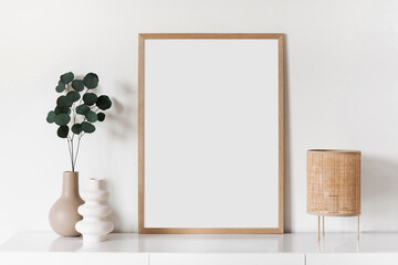 Blank picture frame mockup on white wall. Artwork in minimal interior design. View of modern style...
