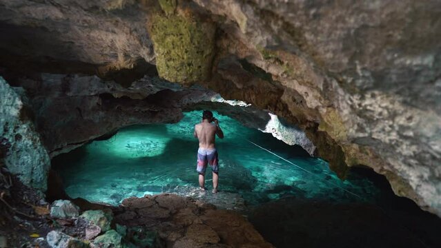 Man ready to swim in Underwater caves of Yucatan Mexico cenotes. Tourism and nature concept. Cave diving in clean and clear underground water. High quality 4k footage