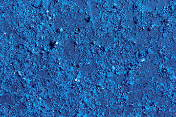 Particles of shiny chips after working out drilling, milling or turning machine in production or factory. Steel scrap materials recycling. Close up of metallic dust in blue light.