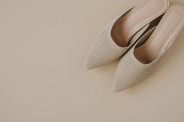 Beige fashion women's shoes on pastel beige background. Elegant luxury fashion concept. Flat lay, top view