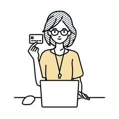 デスクで座ってPCを使いながらクレジットカードを手に持っている教師の女性