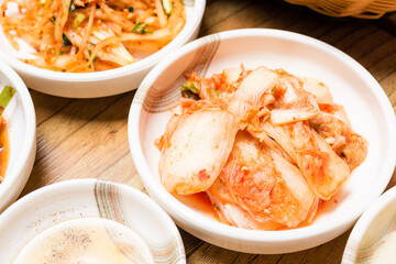 Spicy Kimchi. Korean pickle or Pickled radish vegetables and seasoning on bowl on wood table background, Japanese food