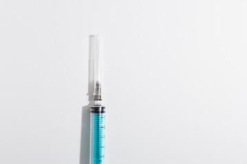 Medical syringe on a white background. A syringe for injection. The concept of health and beauty