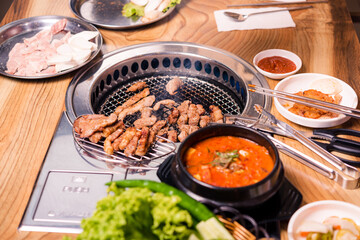 Korean BBQ set. Beef for grill on stove serve with vegetable and soup wood table , Japanese food style barbecue