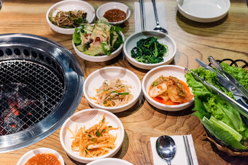 Spicy Kimchi group. Korean pickle or Pickled radish vegetables set and seasoning on bowl on stove serve wood table background, Japanese food