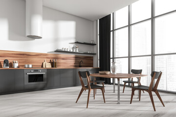 Fototapeta premium Corner view on bright kitchen room interior with dining table