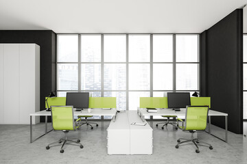 Front view on bright office interior with desk with desktop