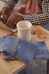African American ceramist using his portable computer