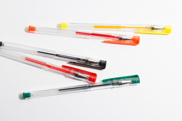 colored gel pens on a white background