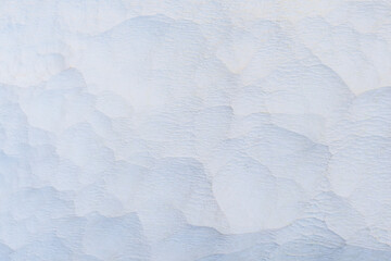 Beautiful nature background with white limestone close up on terraces with thermal water. Soft selective focus. Beauty of nature. Health and wellness concept