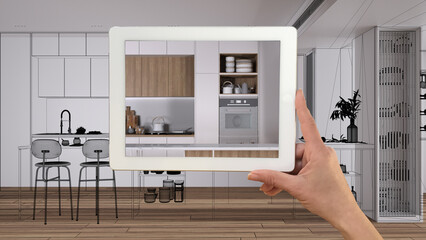 Augmented reality concept. Hand holding tablet with AR application used to simulate furniture products in custom architecture design, black ink sketch, modern kitchen and dining room