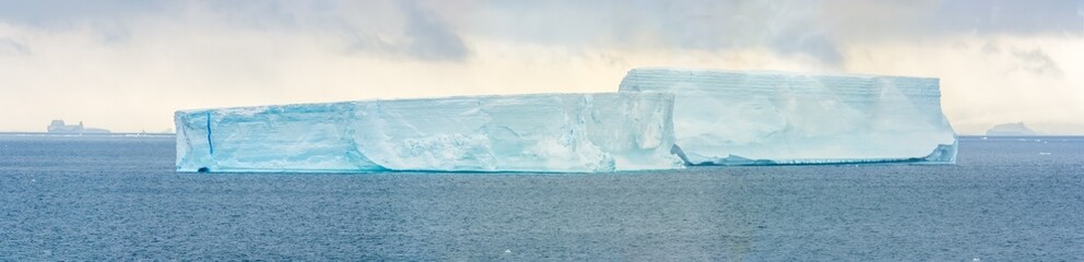 Huge tabular icebergs on the waters off the Antarctic Peninsula, Brown Bluff, Antarctica - obrazy, fototapety, plakaty