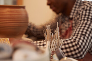 African American potter crafting new earthenware vase
