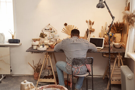 Male ceramist working in modern pottery studio