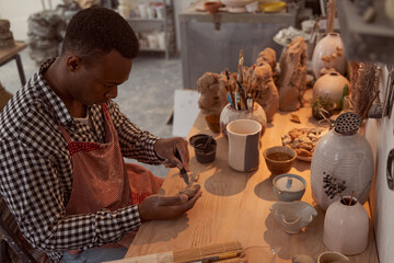 Focused ceramic artist working in his studio