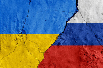 Russia and Ukraine painted flags on a wall with a crack. War, conflict between Ukraine and Russia