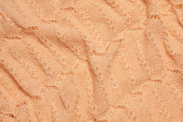 Close up texture of peach color knitted fabric cloth