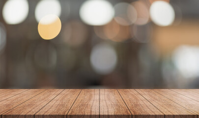 Empty wooden table top with lights bokeh on blur restaurant background.	
