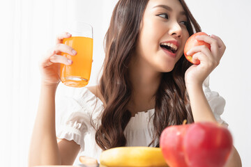 Healthy lifestyle, Close up beautiful young asian woman with fruit juice smiling happy. Healthy...