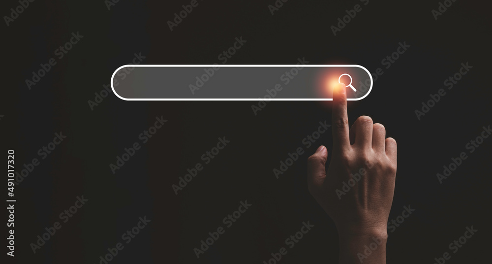 Wall mural hand touching with search icon for search engine optimisation or seo concept to find information by 