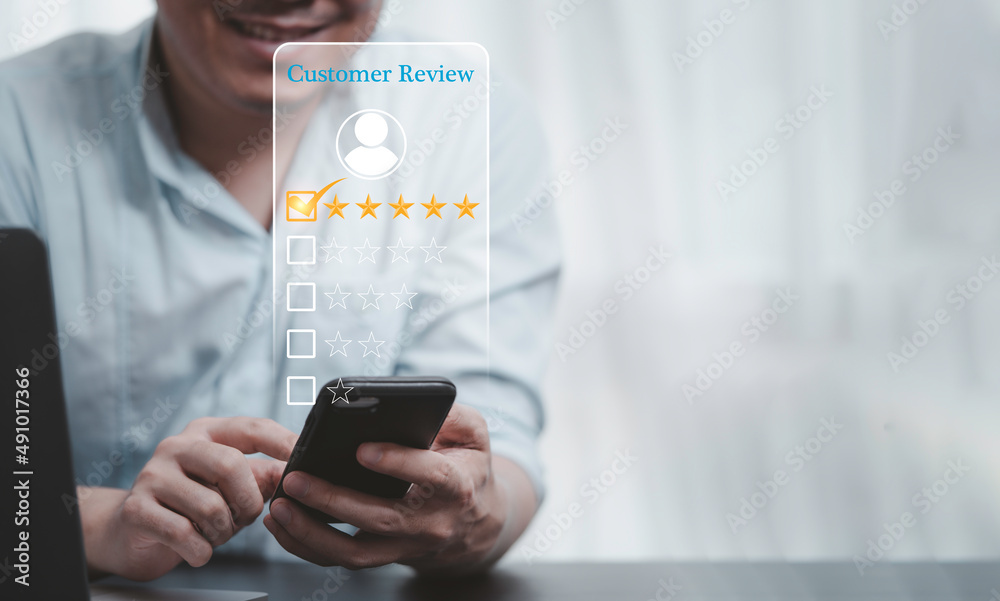 Poster Businessman using smartphone for select smiley face icon for client evaluation and customer satisfaction after use product and service concept.