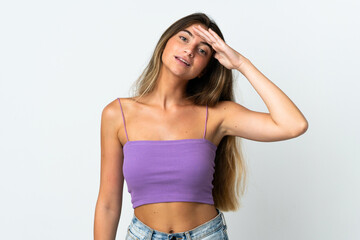 Young caucasian woman isolated  on white background saluting with hand with happy expression