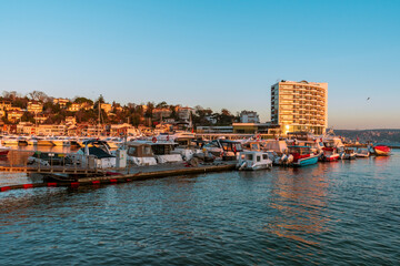 Fototapeta na wymiar sunrise over Tarabya bay of Istanbul. REflection of boats and Tarabya hotel