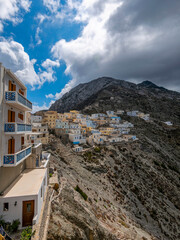 Fototapeta na wymiar Houses on the edge of the western cliff of Olympus, Karpathos island, Greece.