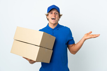 Delivery man over isolated white background with shocked facial expression