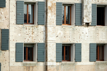 Fototapeta na wymiar Bullet holes in a house facade