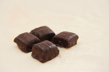 handmade chocolate. Bitter chocolate. Chocolates on parchment paper on a light background