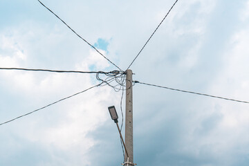 Street electric pole with many electrical wires and fiber optic cables