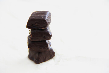 handmade chocolate. Bitter chocolate. Chocolates on parchment paper on a light background
