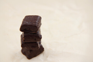 handmade chocolate. Bitter chocolate. Chocolates on parchment paper on a light background