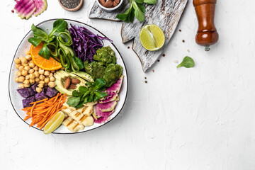 Healthy vegetarian buddha bowl salad with halloumi cheese, avocado, cucumber, chickpeas, watermelon...