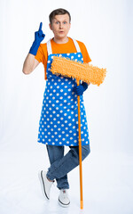 a man in a blue apron, rubber gloves, an orange t-shirt, jeans and white sneakers with a mop....