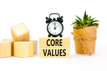 Core values symbol. Concept words Core values on wooden blocks on a beautiful white table white background. Black alarm clock. Business value and core values concept, copy space.
