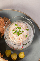Pike caviar in a glass vase on ice with green onions and croutons. Fish caviar, a delicacy. A gourmet dish. Apetizer.