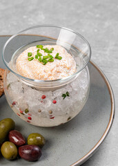 Pike caviar in a glass vase on ice with green onions and croutons. Fish caviar, a delicacy. A gourmet dish. Apetizer.