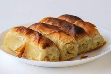 Turkish style potato pie in the form of a roll, made by wrapping dough.