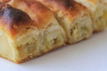 Turkish style potato pie in the form of a roll, made by wrapping dough.