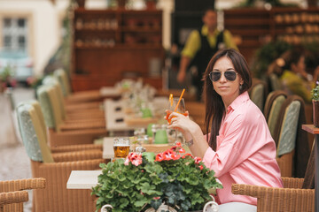 Beautiful woman sitting in outdoors cafe at european city having lunch